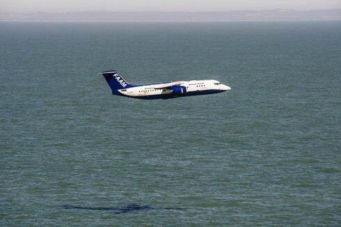 The FAAM research aircraft flying very low over the ocean