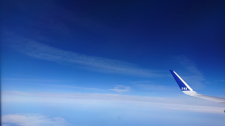 Contrails observed from the window of another aircraft